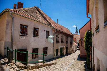 Trebic, Bohemia, Czech Republic, 06 July 2021: Narrow picturesque street with colorful buildings in historic center in medieval city, renaissance and baroque Jewish quarter at summer sunny day.のeditorial素材