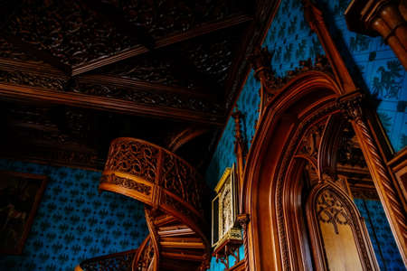 Lednice, Southern Moravia, Czech Republic, 04 July 2021: Castle interior with neo-gothic wooden carved ceiling and furniture, wooden entrance portal above door with a coat of arms, UNESCO chateau.のeditorial素材