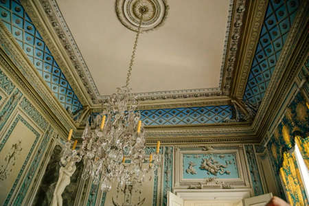 Vranov nad dyji, Southern Moravia, Czech Republic, 03 July 2021: Castle interior, baroque wooden carved furniture, blue and white bedroom, painted walls with floral ornament, crystal chandelier.のeditorial素材