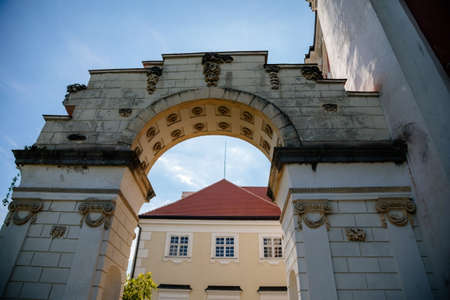 Vranov nad dyji, Southern Moravia, Czech Republic, 03 July 2021: entrance to baroque and gothic medieval castle on hill at sunny summer day, arch twined with rose bushes against the blue sky.のeditorial素材