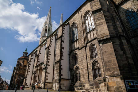 Goerlitz, Germany, 04 September 2021: gothic medieval St. Peter and Paul Church or Peterskirche with two white towers in historical center of city at sunny summer day, Riverbank of Lusatian Neisse.のeditorial素材