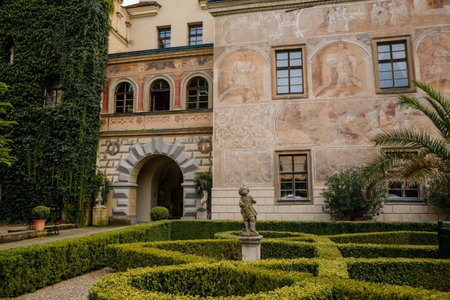 Castolovice, Eastern Bohemia, Czech Republic, 11 September 2021: renaissance castle with tower at sunny day, courtyard with arcades and geometric flower beds, murals and sgraffito plaster on walls.のeditorial素材