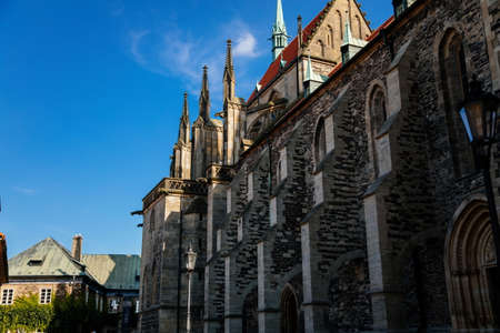 Kolin, Central Bohemia, Czech republic, 10 July 2021: Medieval stone St. Bartholomew? S Church with tower in sunny summer day, arched windows, chimeras and gargoyles, Gothic Cathedral with belfry.のeditorial素材