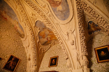 Cervena Lhota, South Bohemia, Czech Republic, 9 October 2021: Castle interior of dining room with baroque stucco and colored frescoes on the ceiling, painting on plaster, floral ornamentsのeditorial素材