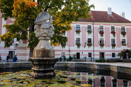 Trebon, South Bohemia, Czech Republic, 9 October 2021: Castle Courtyard, Renaissance chateau with sgraffito mural decorated plaster at facade, fountain with sculpture of bird perched on three heads.のeditorial素材
