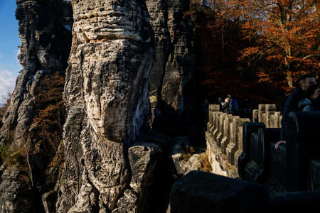 Saxon Switzerland National Park, Germany, 6 November 2021: Bastion Bastei Bridge, Rock Formations in Elbe River Valley, Sandstone Mountains Path, autumn forest landscape at sunny day, rocky valleyのeditorial素材
