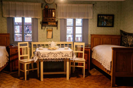 Prerov nad Labem, Czech Republic, 5 December 2021: Interior of traditional regional village house, Christmas in Skanzen, Polabi open-air ethnographic museum, table and tall wooden bedsのeditorial素材