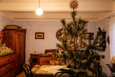 Prerov nad Labem, Czech Republic, 5 December 2021: Interior of traditional regional house, natural Christmas tree decorated with handmade decorations, Skanzen, Polabi open-air ethnographic museumのeditorial素材