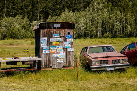 Luzna, Czech Republic, 31 July 2021: Vintage old historic cars displayed at Classic Automobile Museum of American veterans JK Classics, old rusty cars in grass at dump, Route 66, license platesのeditorial素材