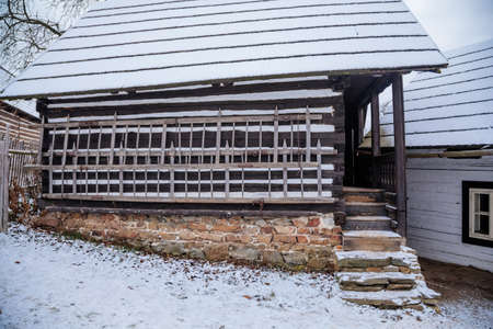 Kourim, Central Bohemia, Czech Republic, 26 December 2021: Traditional rural village wooden house in winter, historic country-style architecture, Christmas in Skanzen, open-air ethnographic museumのeditorial素材