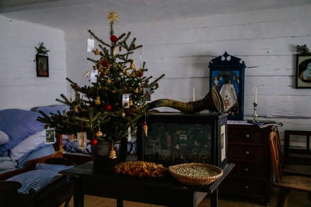 Kourim, Czech Republic, 26 December 2021: Interior of Traditional village house, vanocka or braided sweet bread on table, country-style architecture, Christmas in Skanzen, open-air ethnographic museumのeditorial素材