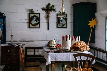 Kourim, Czech Republic, 26 December 2021: Interior of Traditional village house, vanocka or braided sweet bread on table, country-style architecture, Christmas in Skanzen, open-air ethnographic museumのeditorial素材