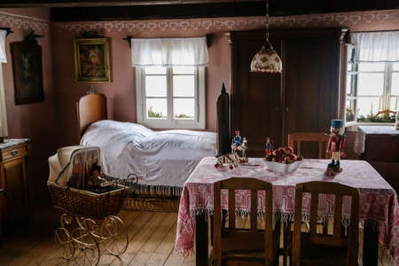 Kourim, Czech Republic, 26 December 2021: Interior of Traditional village house, children's room with beds by window and wooden toys, country-style architecture, open-air ethnographic museumのeditorial素材