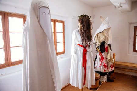 Kourim, Bohemia, Czech Republic, 26 December 2021: Interior of Traditional village house, mask worn on St. Lucia day, St. Lucy or St. Lucille, Lucys women in white coats, open-air ethnographic museumのeditorial素材