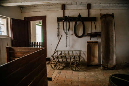 Kourim, Bohemia, Czech Republic, 26 December 2021: Interior of Traditional village house, barn with agricultural tools, troughs and clamps, country-style architecture, open-air ethnographic museumのeditorial素材