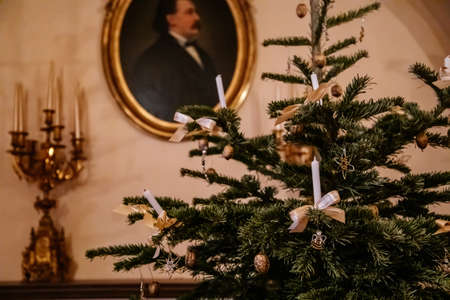 Kolin, Czech Republic, 26 December 2021: Regional Museum Town House Cervinkovsky dum, Interior with Biedermeier style furniture, Christmas tree and decorations, white bows and candles in needlesのeditorial素材