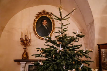 Kolin, Czech Republic, 26 December 2021: Regional Museum Town House Cervinkovsky dum, Interior with Biedermeier style furniture, Christmas tree and decorations, white bows and candles in needlesのeditorial素材