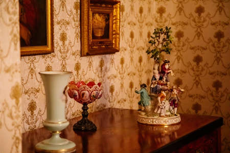 Kolin, Czech Republic, 26 December 2021: Regional Museum Town House Cervinkovsky dum, Interior with Biedermeier style furniture Meissen porcelain, hand-painted figurine stands on chest of drawersのeditorial素材