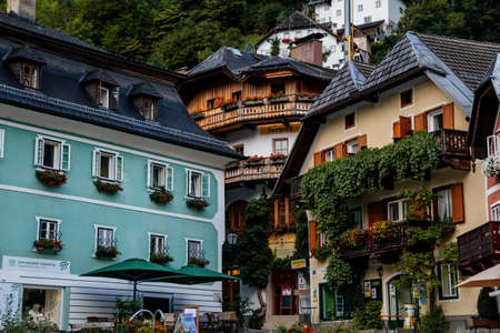 Hallstatt, Austria, 27 August 2021: Colorful scenic picturesque town street at summer day, mountain...