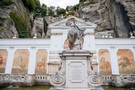 Salzburg, Austria, 28 August 2021: Karajan Square and Horse Pond, place to wash parade horses of prince archbishops, baroque statue of Horse Tamer and unique frescoes on back wall, summer dayのeditorial素材