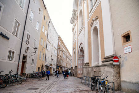 Salzburg, Austria, 28 August 2021: old town narrow street with paving stones near Franciscan Church,...
