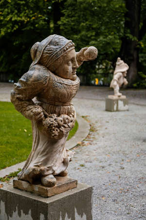 Salzburg, Austria, 28 August 2021: Zwerglgarten or Dwarf Garden in Mirabell palace, Mirabellgarten or Mirabell garden at summer day, was featured in Sound of Music, Famous stone statues on green grassのeditorial素材