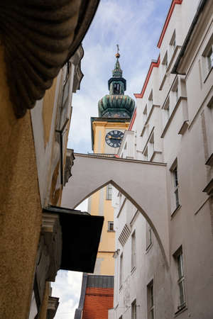 Linz, Austria, 27 August 2021: Medieval catholic Baroque Stadtpfarrkirche, clock bell tower, Parish...