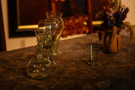 Karlstejn, Bohemia, Czech Republic, 12 March 2022: historical replica of forest medieval historical wine glass on table, medieval gothic castle interior, antique wood carved furniture, dining roomのeditorial素材