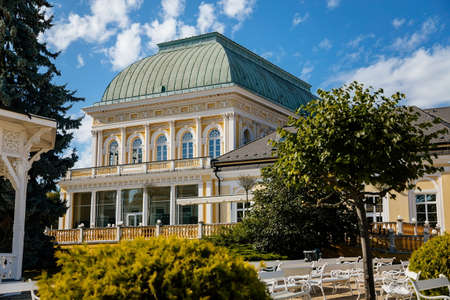 Frantiskovy Lazne, Western Bohemia, Czech Republic, 14 August 2021: Social House or Spolecensky dum at Peace Square, yellow baroque historical building, spa town Franzensbad at sunny summer dayのeditorial素材