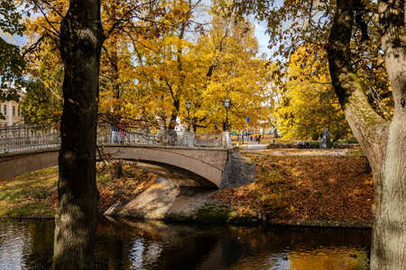 Riga, Latvia, 19 October 2021: Beautiful Bastejkalna Central Park with canals near the Latvian National Opera at autumn sunny day, bridge over waterのeditorial素材