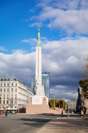 Riga, Latvia, 14 October 2021: Freedom Monument honoring soldiers killed during Latvian War of Independence, statue of granite, travertine and copper on Freedom Boulevard on sunny dayのeditorial素材
