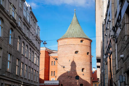 Riga, Latvia, 19 October 2021: Powder tower, Narrow picturesque street, Facade of colorful buildings...