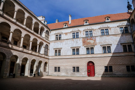 Litomysl, Czech Republic, 17 April 2022: Renaissance aristocratic castle, UNESCO World Heritage Site, chateau with sgraffito mural decorated plaster at facade at sunny day, courtyard with arcadesのeditorial素材