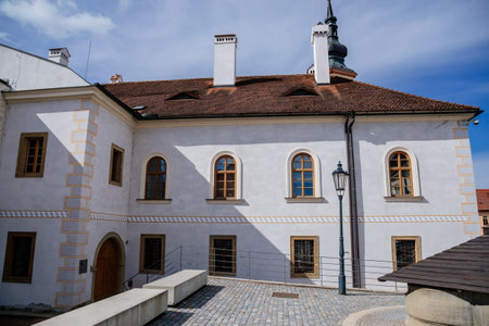 Litomysl, Czech Republic, 17 April 2022: narrow picturesque street with medieval colorful gothic merchant houses at sunny summer day, historic renaissance and baroque buildings, medieval churchのeditorial素材