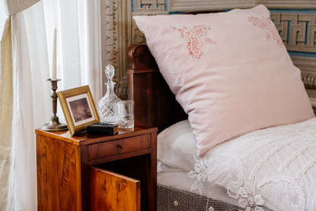 Litomysl, Czech Republic, 17 April 2022: castle chateau representative interior with baroque classic furniture, carved wooden bed and armchair in bedroom, ladies table with mirror and decorationsのeditorial素材