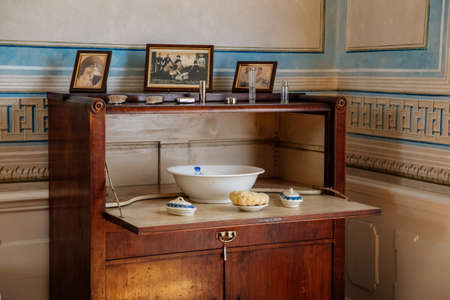 Litomysl, Czech Republic, 17 April 2022: castle chateau representative interior with baroque classic furniture, bedroom with bathroom, antique white ceramic tiled stove, jug and bowl on wash tableのeditorial素材