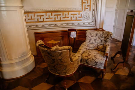 Litomysl, Czech Republic, 17 April 2022: castle chateau baroque representative interior with baroque classic furniture, soft carved sofa and armchairs, paintings and mirrors on the wallsのeditorial素材