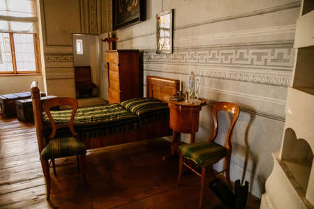 Litomysl, Czech Republic, 17 April 2022: castle chateau representative interior with baroque classic furniture, carved wooden bed and armchair in bedroom, ladies table with mirror and decorationsのeditorial素材
