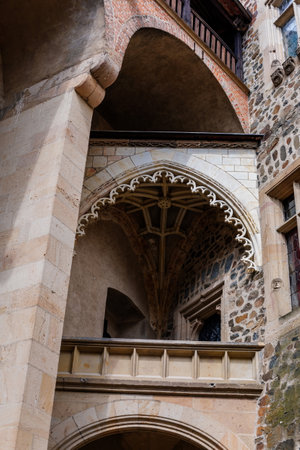 Krivoklat, Czech Republic, 21 August 2022: Courtyard of fortified medieval royal gothic castle, National cultural landmark in summer day, Fortress walls and tower, gothic vaulted balconyのeditorial素材