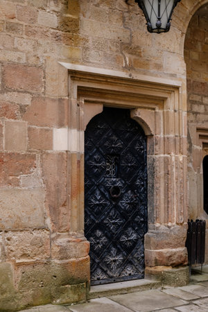 Krivoklat, Czech Republic, 21 August 2022: Courtyard of fortified medieval royal gothic castle, National cultural landmark in summer day, Fortress walls, antique wrought iron doors, flowers ornamentsのeditorial素材
