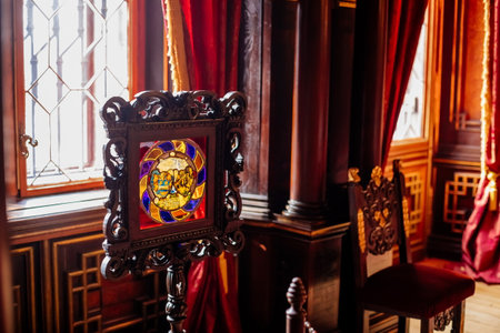 Hradek u nechanic, Czech Republic, 8 October 2022: Castle or chateau interior with wooden carved furniture, historical stained glass with coat of arms near windowsのeditorial素材
