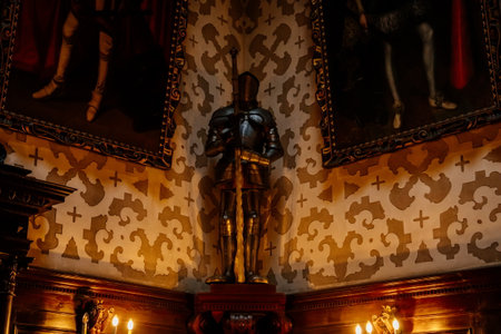 Hradek u nechanic, Czech Republic, 8 October 2022: Castle or chateau interior with neo-gothic wooden carved furniture, main salon portraits, knightly armor next to the fireplace, renaissance stuccoのeditorial素材