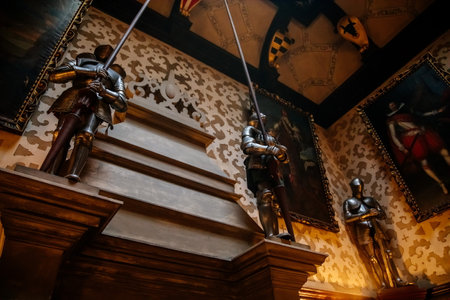 Hradek u nechanic, Czech Republic, 8 October 2022: Castle or chateau interior with neo-gothic wooden carved furniture, main salon portraits, knightly armor next to the fireplace, renaissance stuccoのeditorial素材