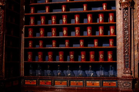 Kuks, Czech Republic, 8 October 2022: interior of historic pomegranate apple pharmacy, vintage glass bottles on wooden table, shelf, medical background, museum antique drugstore, jars with cork lidsのeditorial素材