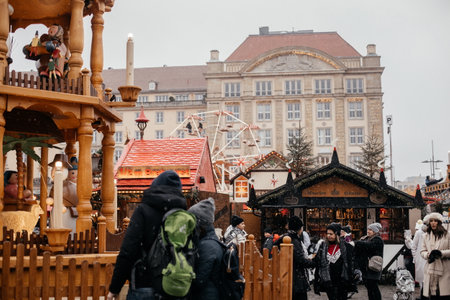 Dresden, Saxony, Germany, 10 December 2022: Christmas outdoor market stall decorations with fairy c lights, vibrant signs banners, coniferous spruce green branches, Striezelmarkt on Altmarkt squareのeditorial素材