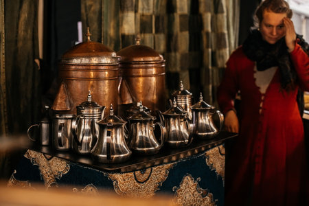 Dresden, Saxony, Germany, 10 December 2022: Part of the kitchen interior of an Arabian street coffee shop, small teapots for tea, for Turkish and Arabic coffee stand on low table, winter day and snowのeditorial素材