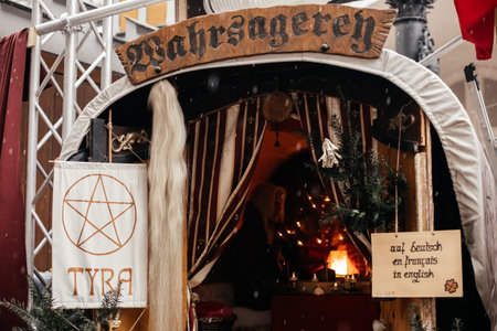 Dresden, Saxony, Germany, 10 December 2022: Christmas medieval outdoor market stall decorations with fairy with lights, Stallhof next to palace residence, gypsy kibitka fortune-tellers on tarot cardsのeditorial素材
