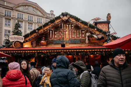 Dresden, Saxony, Germany, 10 December 2022: Christmas outdoor market stall decorations with fairy c lights, vibrant signs banners, coniferous spruce green branches, Striezelmarkt on Altmarkt squareのeditorial素材