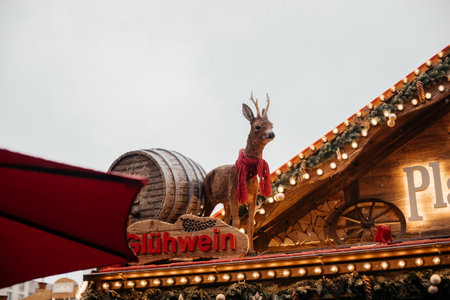 Dresden, Saxony, Germany, 10 December 2022: Christmas outdoor market stall decorations with fairy c lights, vibrant signs banners, coniferous spruce green branches, Striezelmarkt on Altmarkt squareのeditorial素材