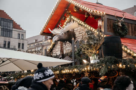 Dresden, Saxony, Germany, 10 December 2022: Christmas outdoor market stall decorations with fairy c lights, vibrant signs banners, coniferous spruce green branches, Striezelmarkt on Altmarkt squareのeditorial素材